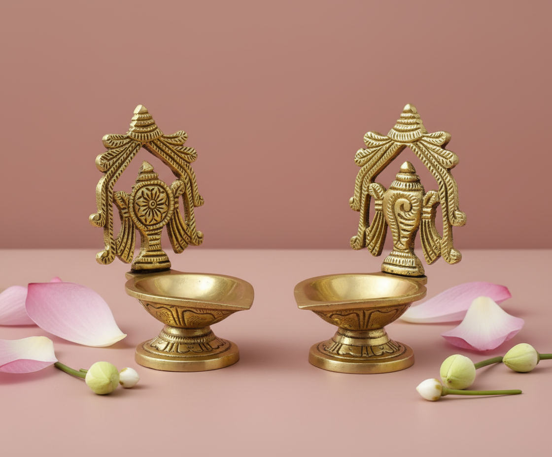 Brass diya on sage or dusty rose background with lotus petals